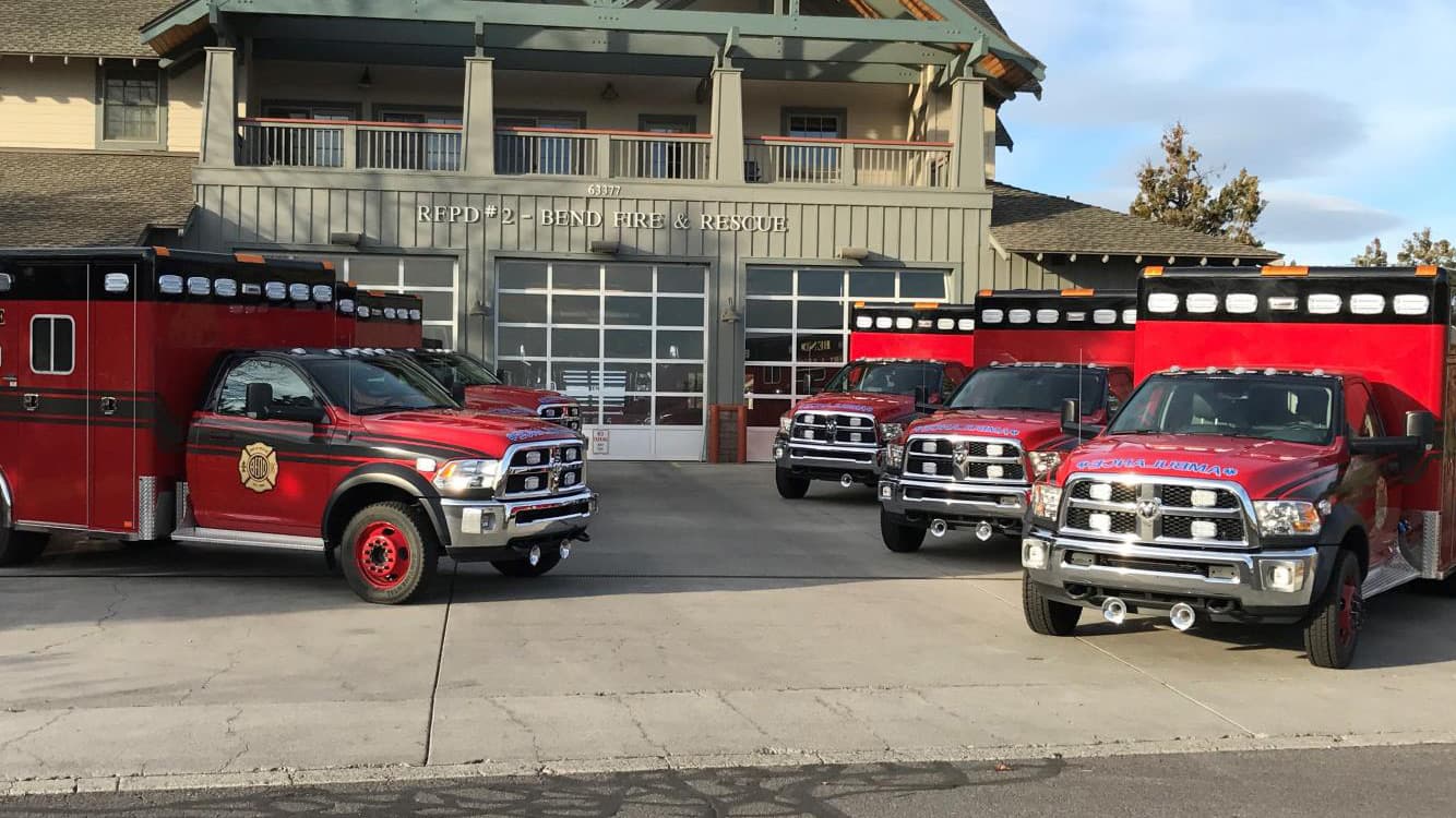 Bend Fire & Rescue ambulances parked outside a fire station