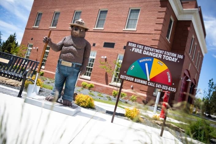 Smokey Bear statue and fire danger sign outside Bend Fire Station 1